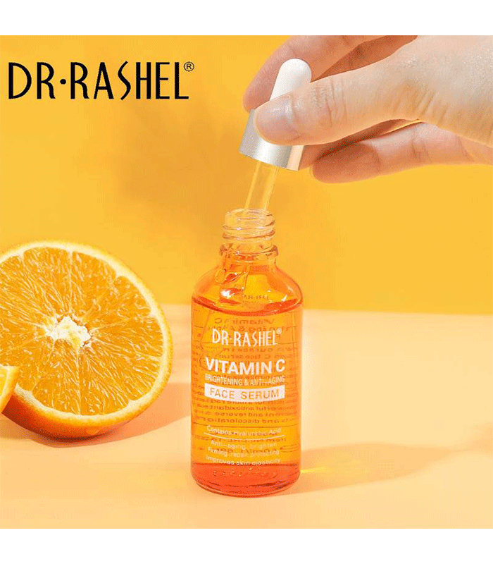 A bottle of Dr Rashel Vitamin C Serum with a dropper applicator and Orange in Background